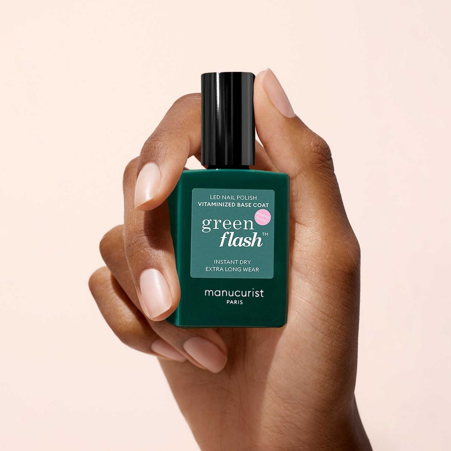 Main tenant un flacon de base coat vitaminée Green Flash™